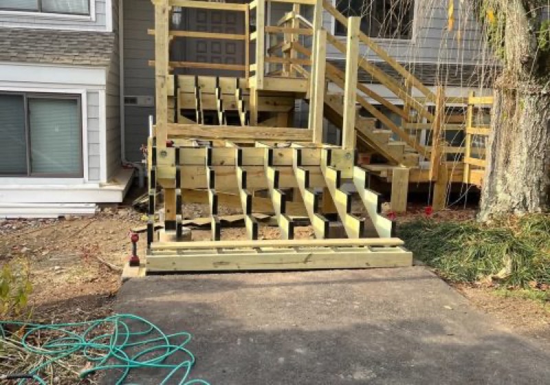 A new backyard deck being framed in pressure-treated lumber