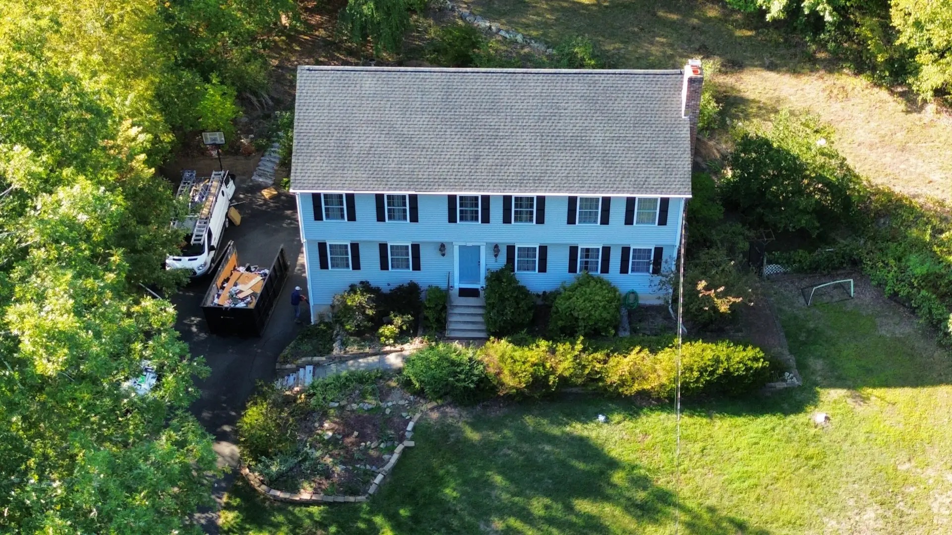Aerial view of a two-story Connecticut home with a freshly installed asphalt shingle roof by JML Construction